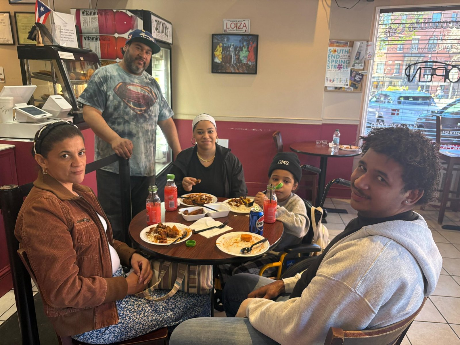 A family sharing a meal together at a café in Boston