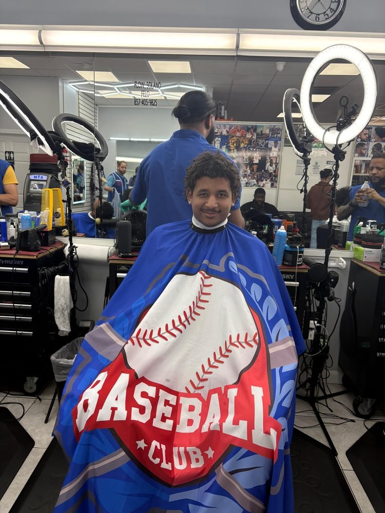 A young man smiling during a haircut