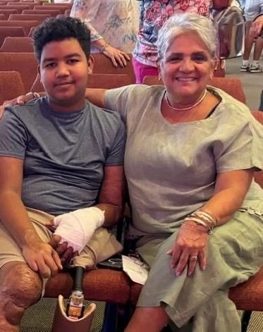 A boy with Martha Garzón at a community gathering