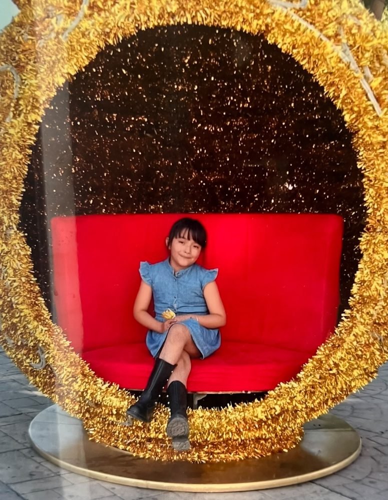 A girl in a blue dress at a festive celebration